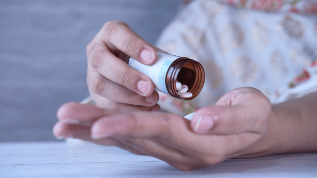 Person taking antibiotics for strep throat